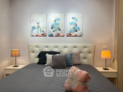 Cozy bedroom with elegant decor and soft lighting, featuring a plush bed and stylish artwork.
