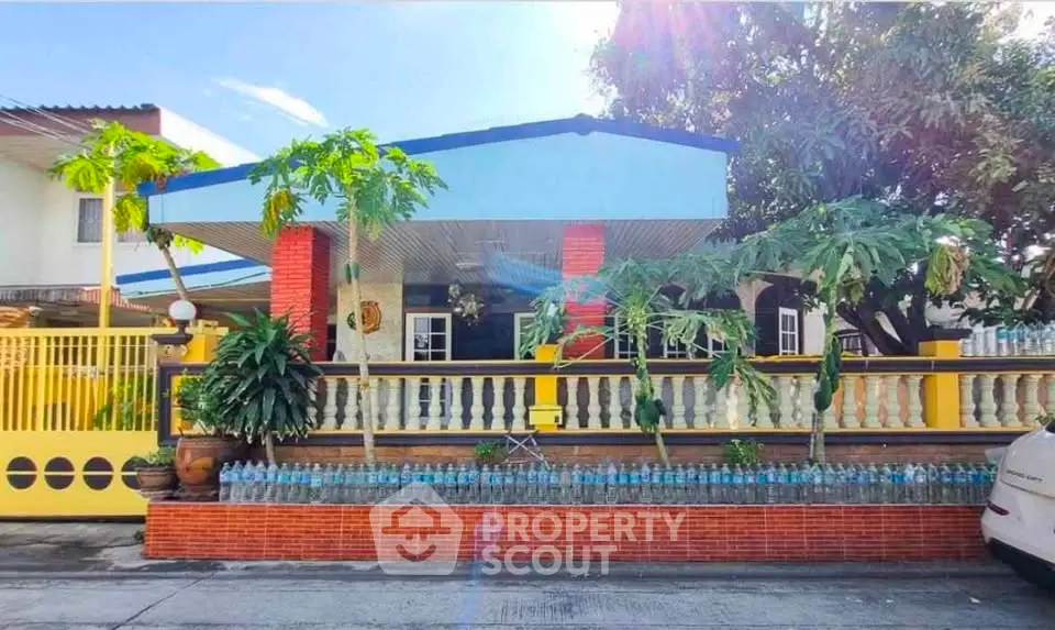 Charming single-story home with vibrant exterior and lush garden, perfect for family living.