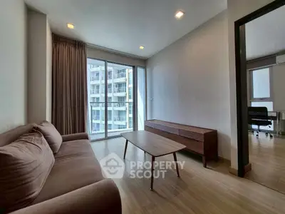 Modern living room with cozy sofa and large windows in urban apartment