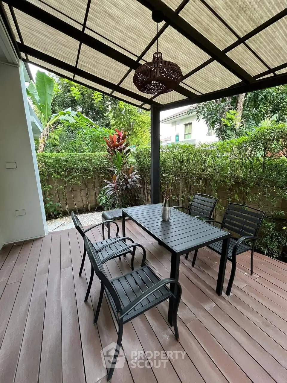 Charming outdoor patio with elegant dining set and lush garden view