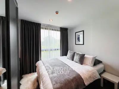 Modern bedroom with stylish decor and large window for natural light