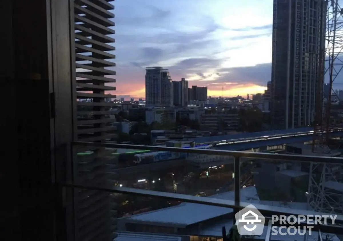 Stunning cityscape view from a high-rise balcony at sunset, showcasing urban skyline.