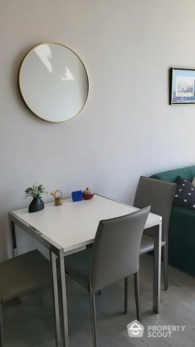 Modern dining area with sleek table and chairs, stylish decor and wall art