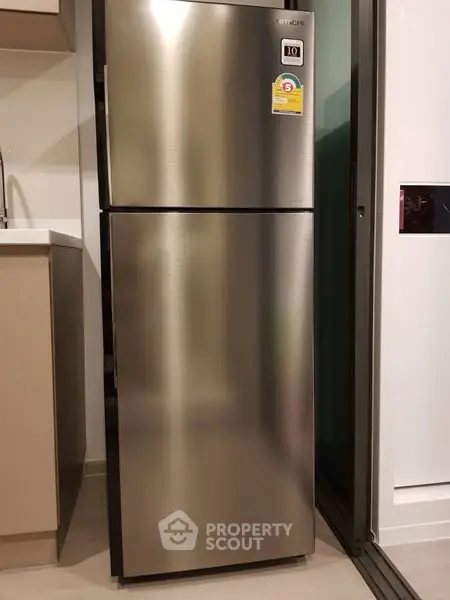 Modern kitchen with sleek stainless steel refrigerator and stylish cabinetry.