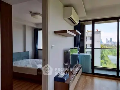 Modern apartment with bedroom and living area, featuring city view and sleek interior design.