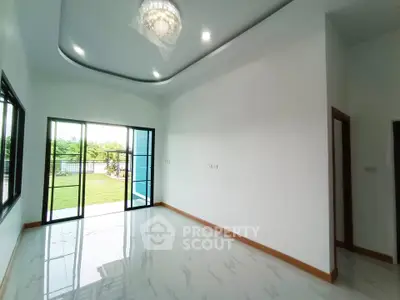 Spacious living room with elegant ceiling design and garden view