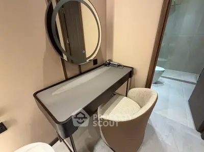 Elegant vanity area in modern bathroom with stylish chair and round mirror