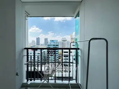 Urban balcony with city skyline view, perfect for enjoying the vibrant cityscape.