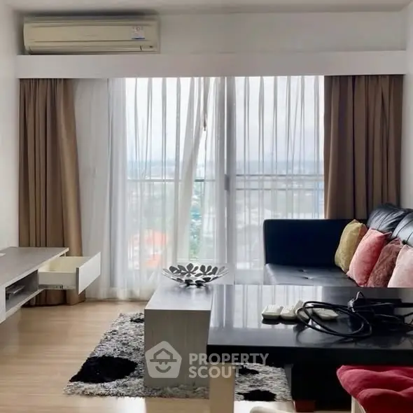 Modern living room with large window and stylish furniture