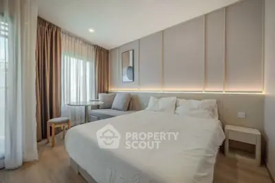 Elegant bedroom with modern decor, featuring a cozy bed, stylish seating area, and soft ambient lighting.