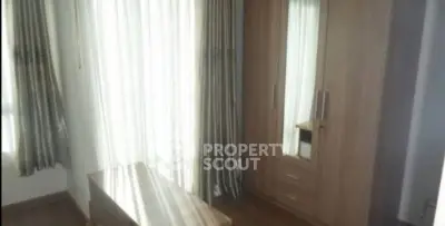 Cozy bedroom with wooden wardrobe and natural light