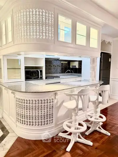 Elegant kitchen with bar seating and modern appliances in a stylish open layout