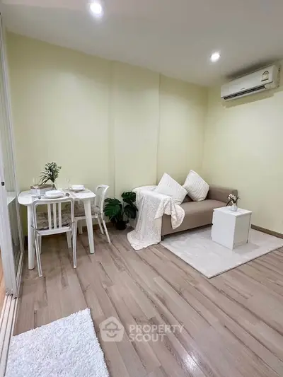 Cozy living room with modern decor and dining area, featuring soft lighting and elegant furnishings.