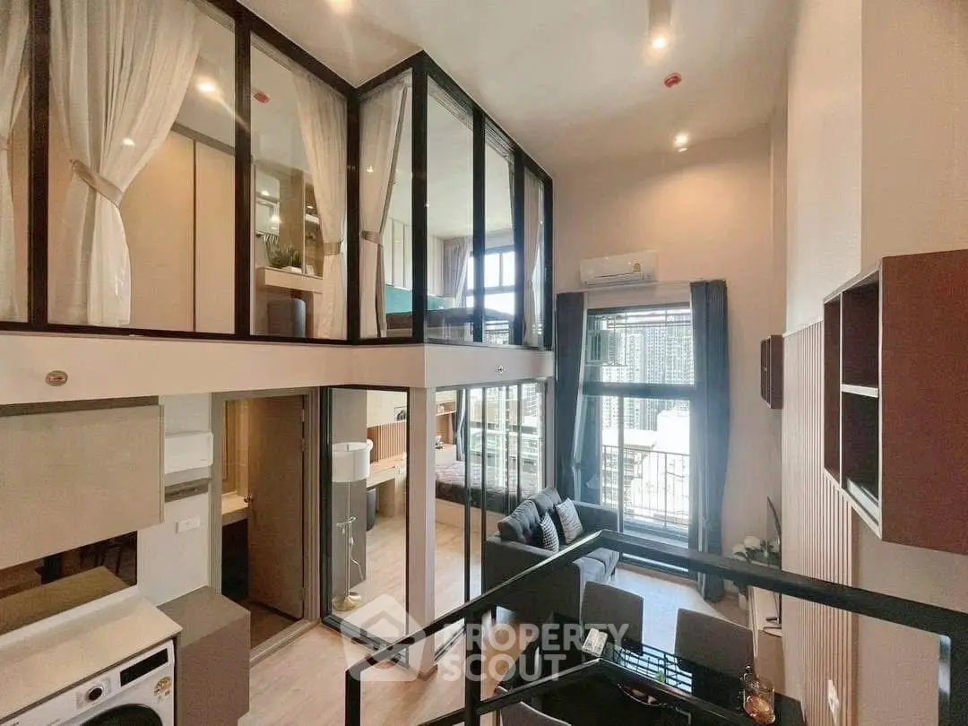 Modern duplex apartment with floor-to-ceiling windows and stylish interior design.