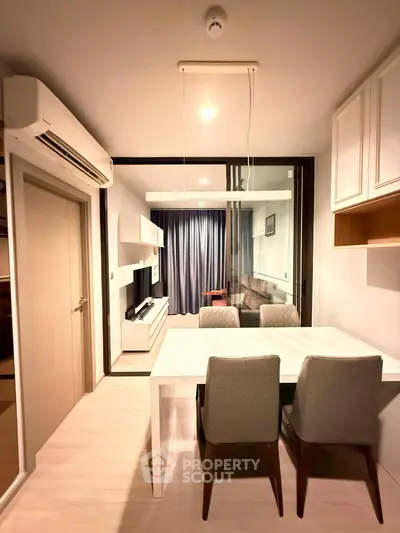 Modern apartment dining area with sleek furniture and ambient lighting