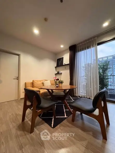 Modern living room with stylish furniture and large window offering city view