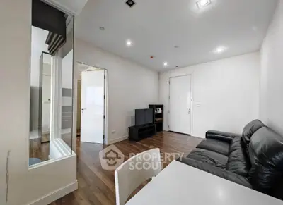 Modern living room with sleek leather sofa and wooden flooring