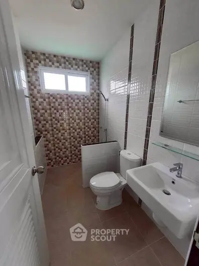 Modern bathroom with stylish tile design and natural light