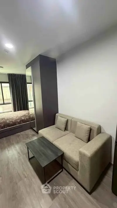 Modern studio apartment with cozy living area and natural light