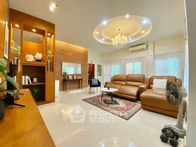 Luxurious living room with elegant chandelier and leather sofas in modern home