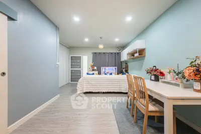 Modern bedroom with stylish decor and dining area, featuring soft lighting and contemporary furniture.
