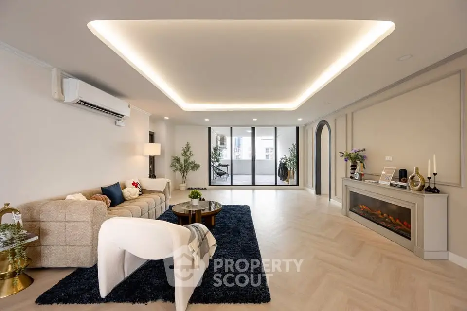 Spacious modern living room with elegant lighting and cozy fireplace