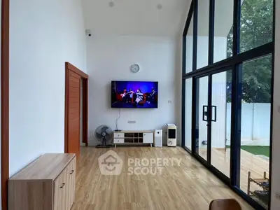 Spacious modern living room with high ceilings and large windows for natural light.