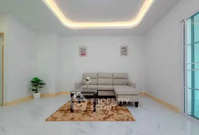 Spacious modern living room with elegant lighting and cozy seating area.