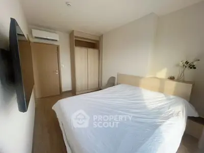 Cozy bedroom with modern decor and ample natural light