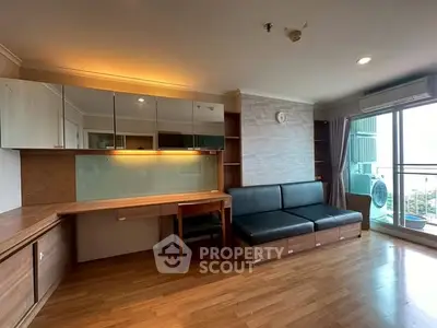Spacious living room with modern decor and balcony access