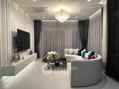 Luxurious living room with elegant chandelier and modern decor