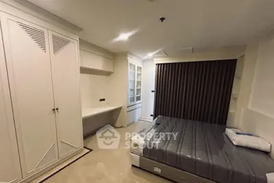 Modern bedroom with built-in wardrobe and cozy lighting in a stylish apartment.