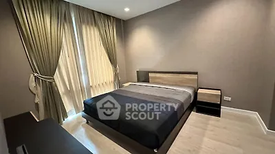 Modern bedroom with elegant curtains and stylish furniture in a cozy apartment.
