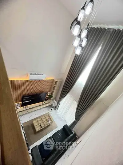 Stunning modern living room with high ceilings and elegant lighting