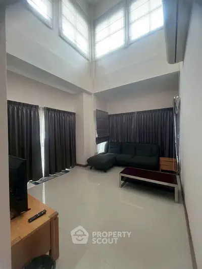 Spacious living room with high ceilings and modern furniture