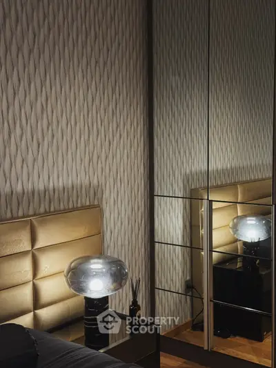 Luxurious bedroom with elegant mirrored wardrobe and modern lamp