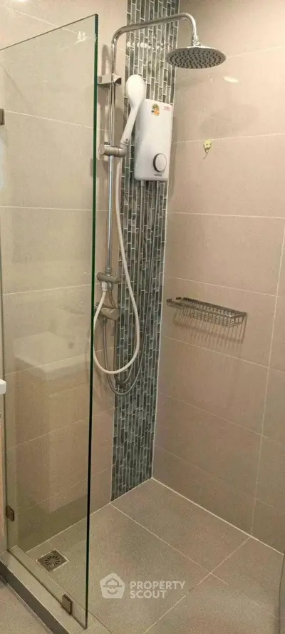 Modern bathroom with glass shower enclosure and sleek tile design