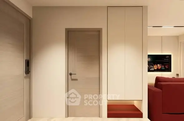 Modern interior with sleek design and cozy living room featuring red sofa and built-in storage.