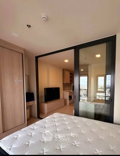 Modern bedroom with sliding glass doors and city view