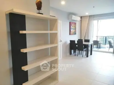 Spacious modern living room with dining area and balcony view
