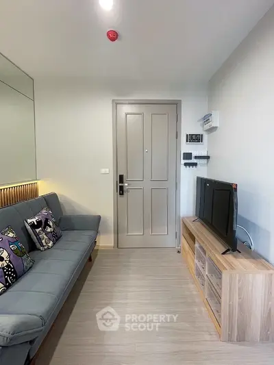 Modern living room with stylish sofa and TV unit, perfect for cozy relaxation.