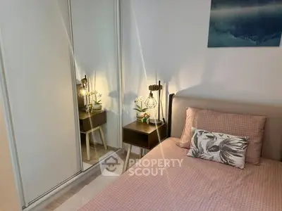 Cozy bedroom with mirrored wardrobe and stylish decor