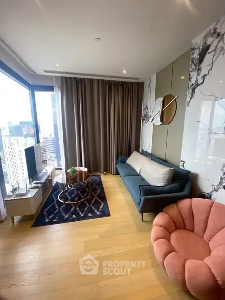 Stylish modern living room with city view, featuring chic furniture and elegant decor.