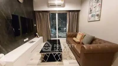 Modern living room with city view, stylish decor, and comfortable seating.