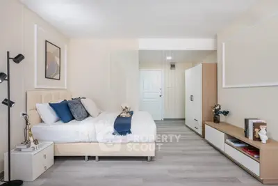 Modern bedroom with stylish decor and ample storage in a cozy apartment.