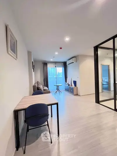 Spacious modern living room with large windows and stylish furniture