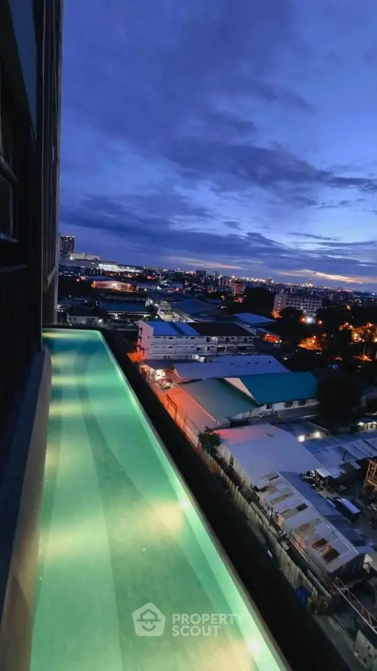 Stunning rooftop pool with panoramic city views at dusk, perfect for luxury living.