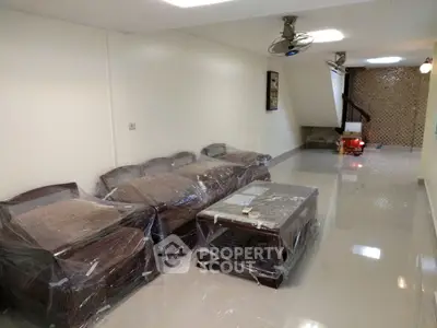 Spacious living room with modern furniture and glossy tiled floor, perfect for family gatherings.