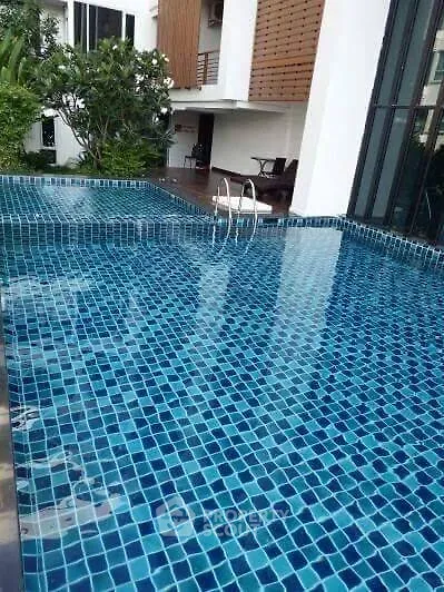 Luxurious residential pool with modern design and serene surroundings.