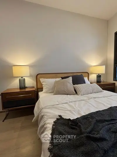 Cozy bedroom with stylish decor and warm lighting, perfect for relaxation.
